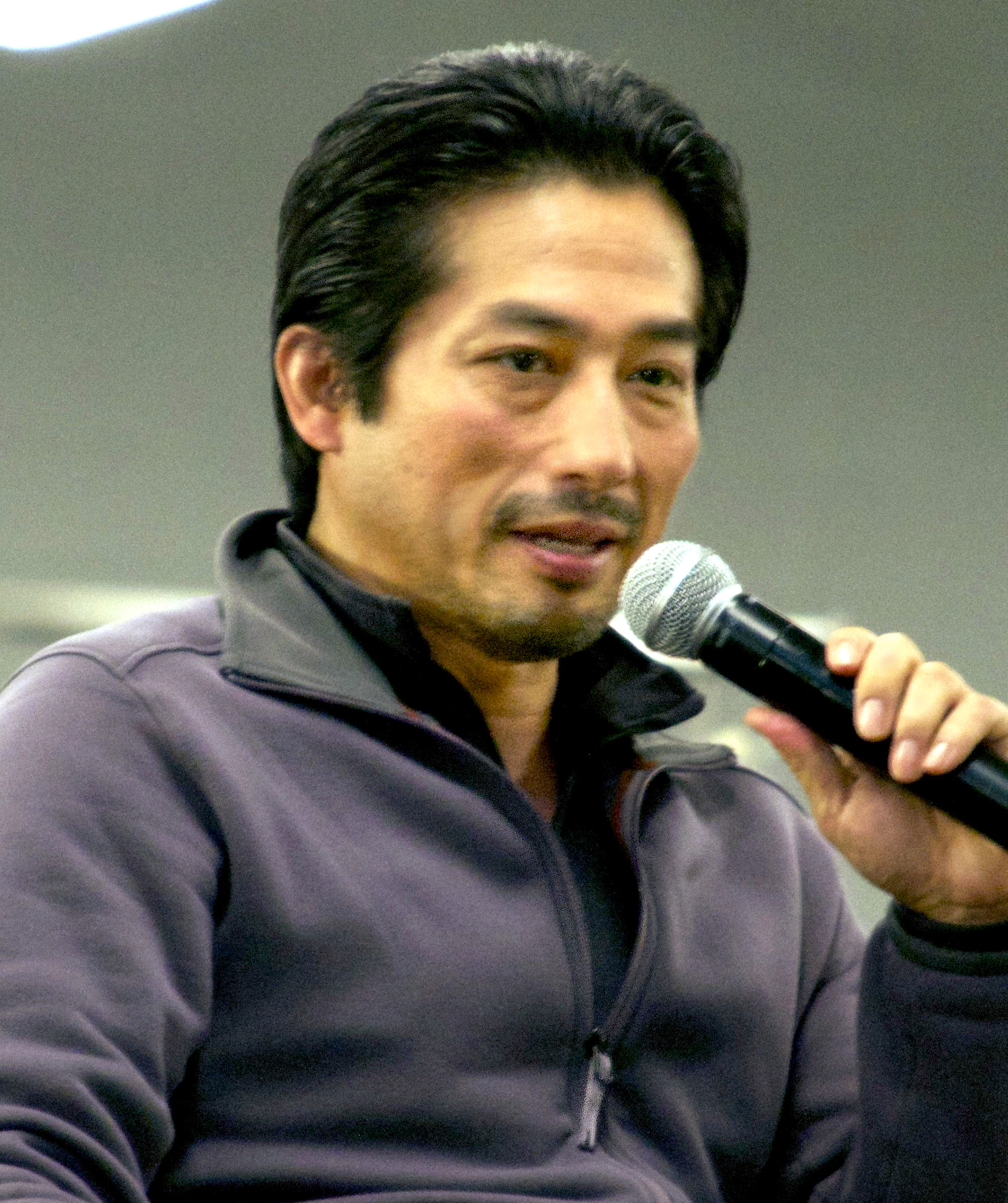 Hiroyuki Sanada as Lord Yoshii Toranaga in dark samurai armor before a misty feudal-Japanese castle in FX's Shogun