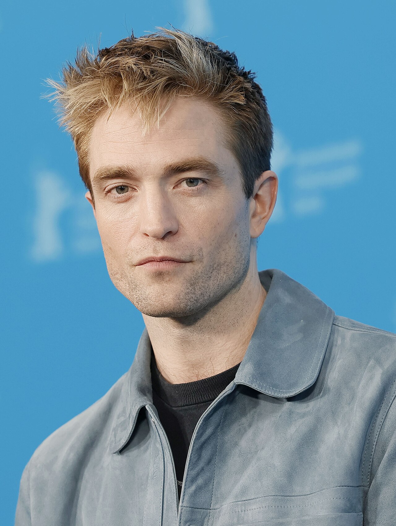 Robert Pattinson as a cowled, rain-soaked Batman emerging from shadow in Matt Reeves' The Batman (2022)